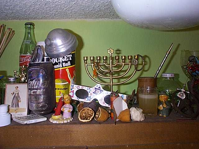 french playing cards, channukah glasses which make all points of light refract like miraculous, a tiny cermaic svejk from childhood's dusty bookshelves, and a mennorah b/c we're closet unitarians