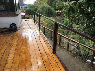 trex reveal
                      rail posts and cross-pieces in place, a golden
                      cedar deck in the rain, saturday